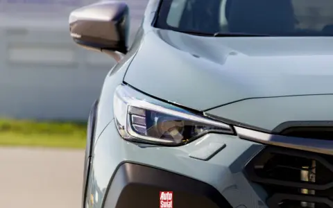 Szary, nowoczesny SUV z reflektorem LED. Logo "Auto Świat" na zderzaku sugeruje, że to auto top marki.
